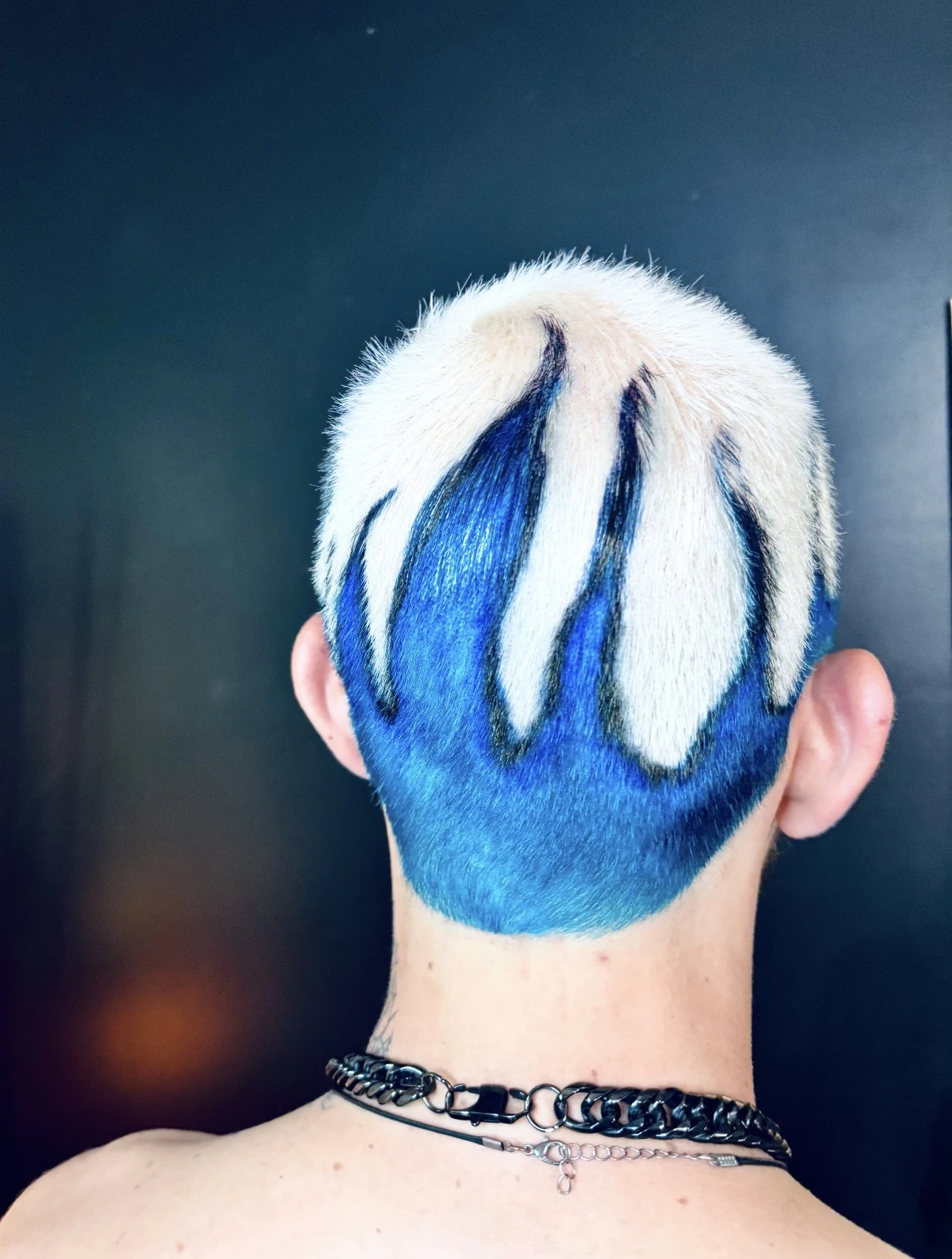 Short white and electric blue custom color haircut viewed from the back