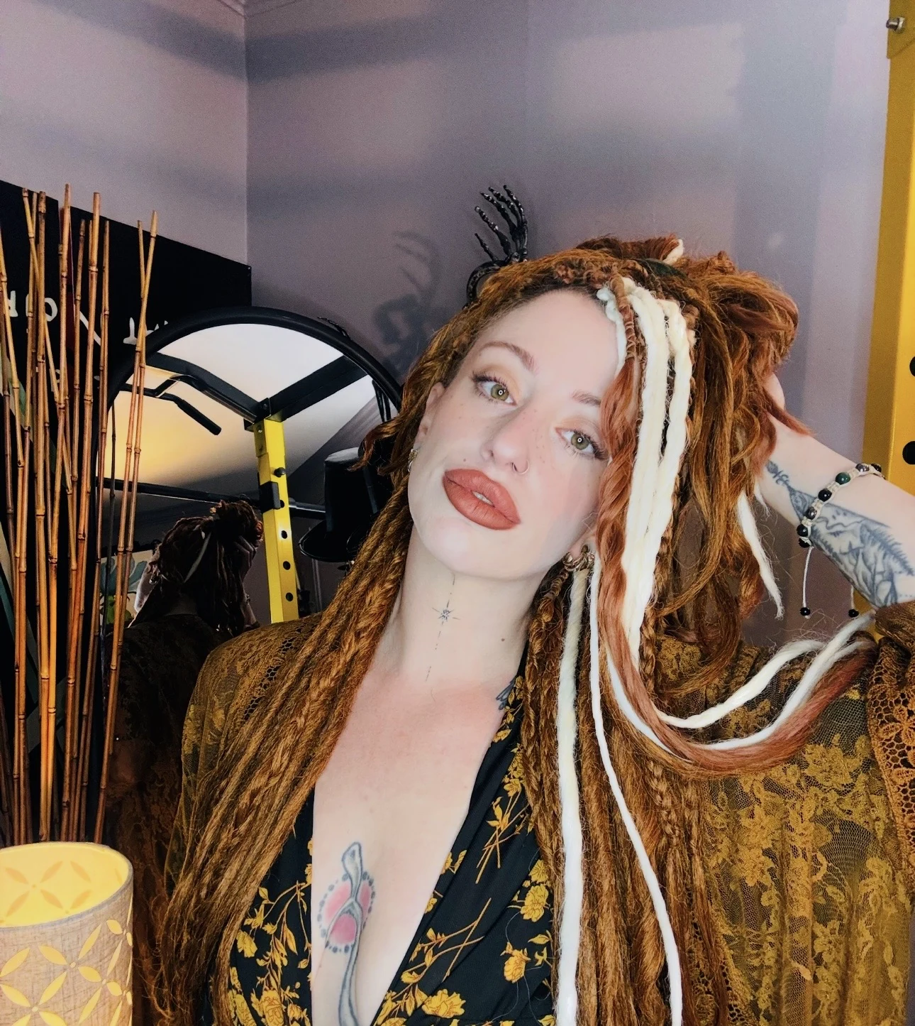 Long copper dreadlocks with light accent locs worn in a finished style